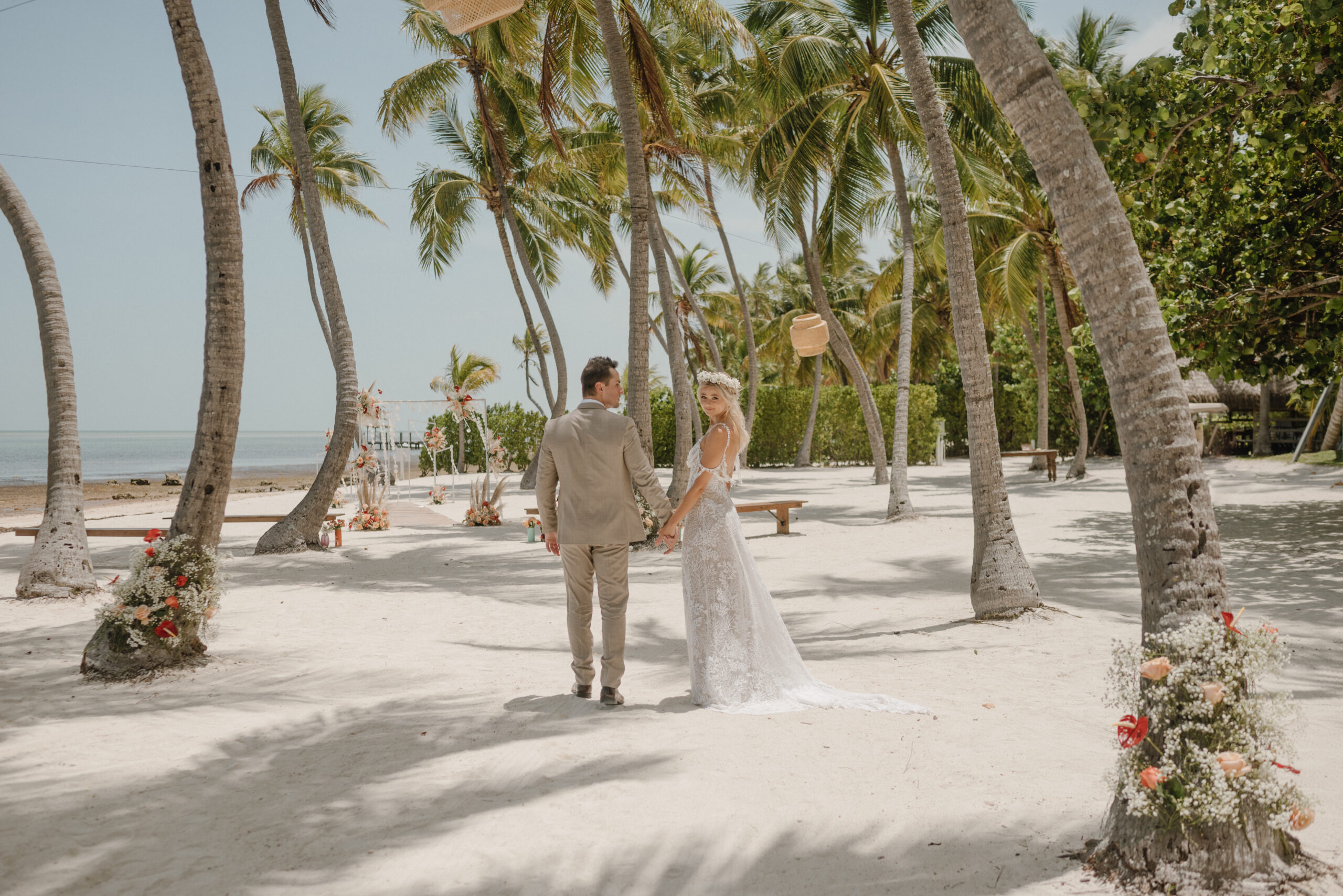 bride and groom under palm tree in tropical florida keys